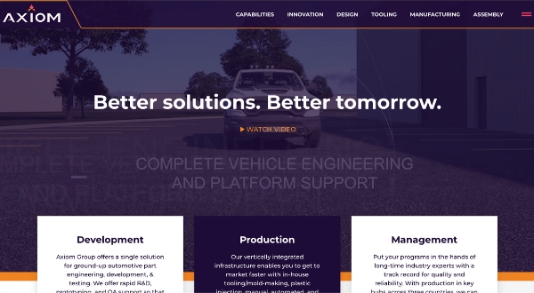 A website homepage for Axiom Group, designed by Loomo Marketing, shows a car on a road with the headline Better solutions. Better tomorrow. and menu options like Capabilities, Innovation, and Manufacturing across the top.